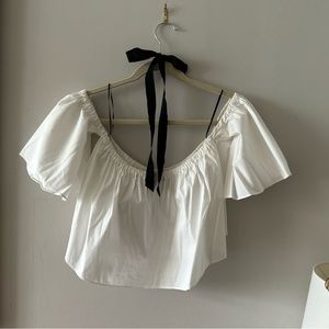 Zara’s white off-shoulder crop top.